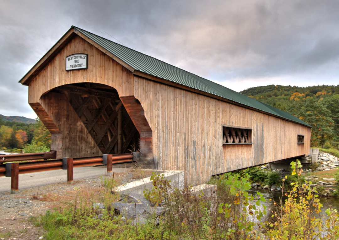 A house with a bridge in the background

Description automatically generated